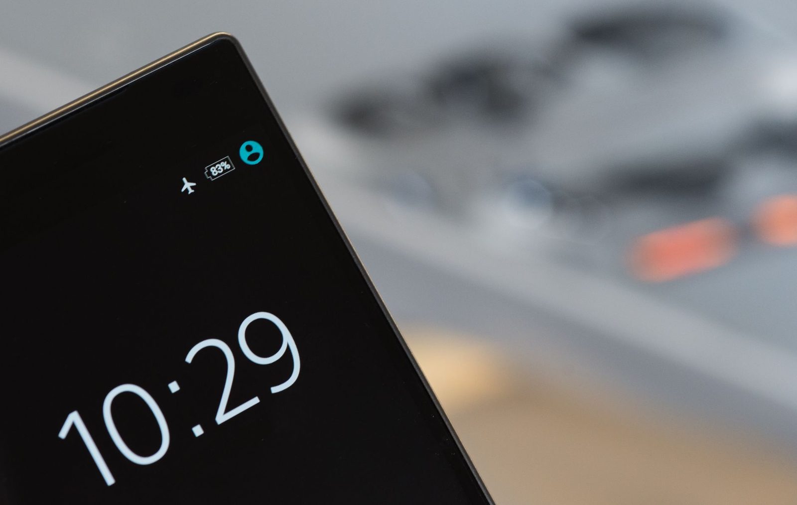 Smartphone screen showing 10:29, 83% battery and airplane mode, against a blurred background
