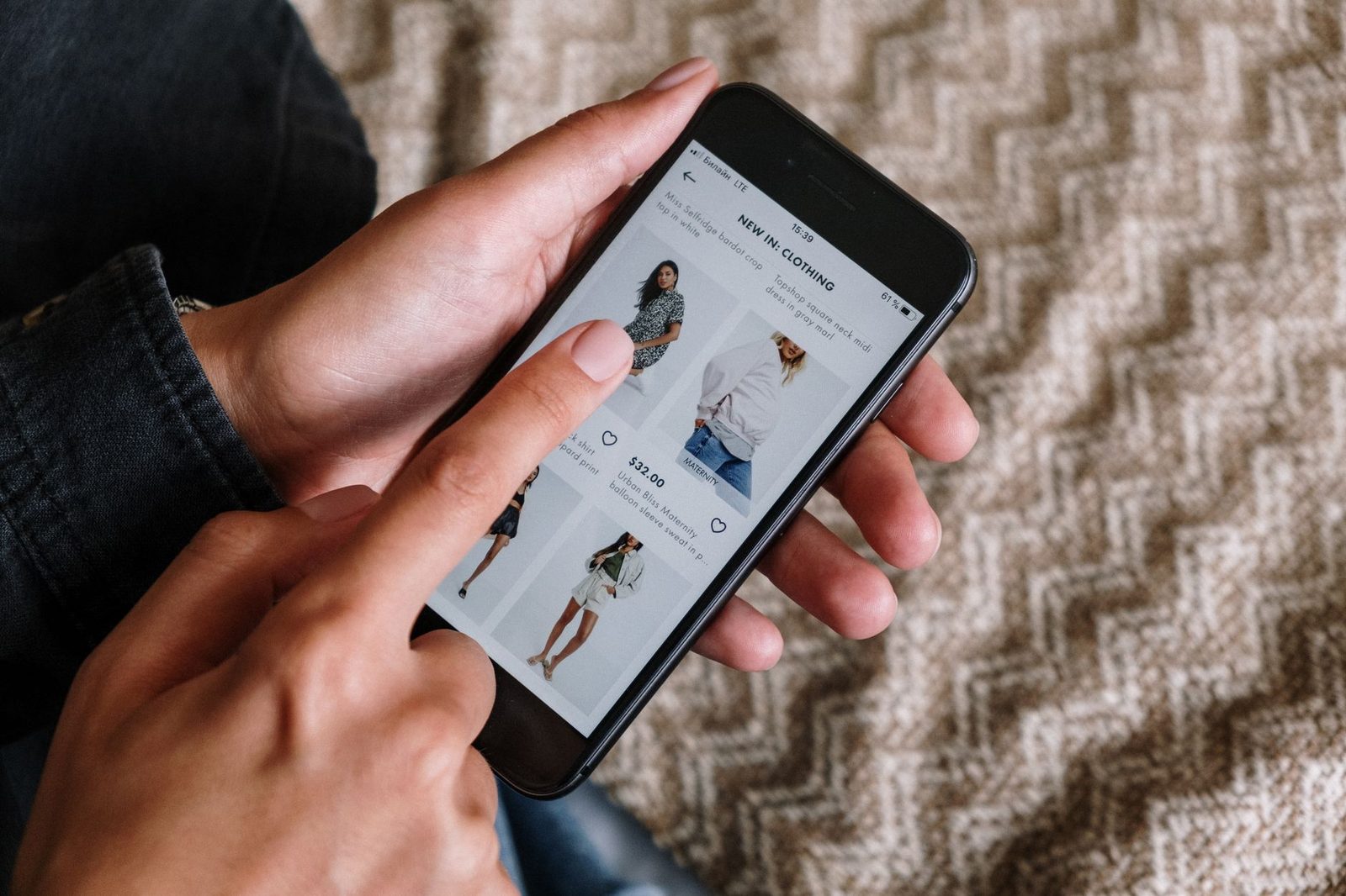 Mani che tengono uno smartphone con un'app di shopping, rete mobile LTE visibile in cima allo schermo